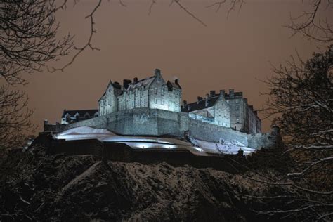 Edinburgh Castle Scotland Uk Illuminated At Night In The Winter Snow