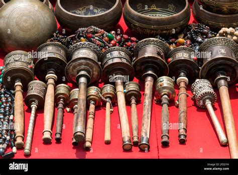 Bunch Of Tibetan Traditional Souvenirs Lying On Red Table Market In