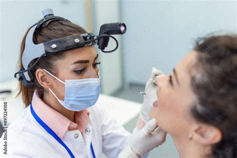 Female Patient Opening Her Mouth For The Doctor To Look In Her Throat Female Doctor Examining