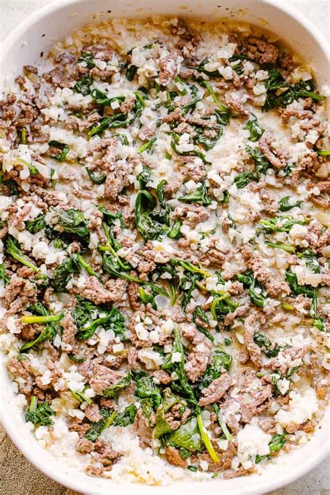 Finely chop a whole bulb of garlic into small pieces and mix in with the beef. Cheesy Ground Beef and Cauliflower Rice Casserole is ...