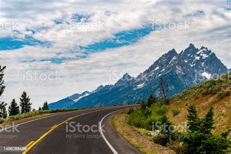 Majestic Teton Mountain Range And Roadway Epic Road Trip Beauty In