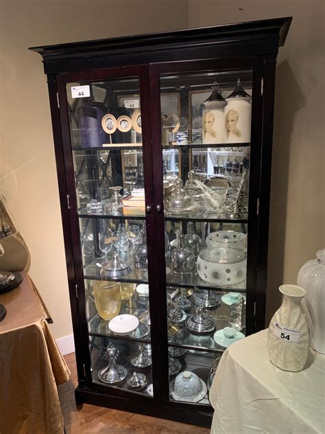 Hampton bay hampton assembled 30x18x12 in. DARK WOOD CROSS SIDE 2 DOOR GLASS CURIO CABINET WITH ASSORTED DECOR ITEMS 15 X 43 X 79 INCHES ...