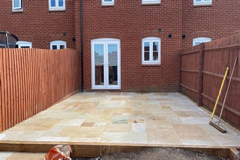 Indian Sandstone Slabbed Patio With Railway Sleepers Step And New Turf