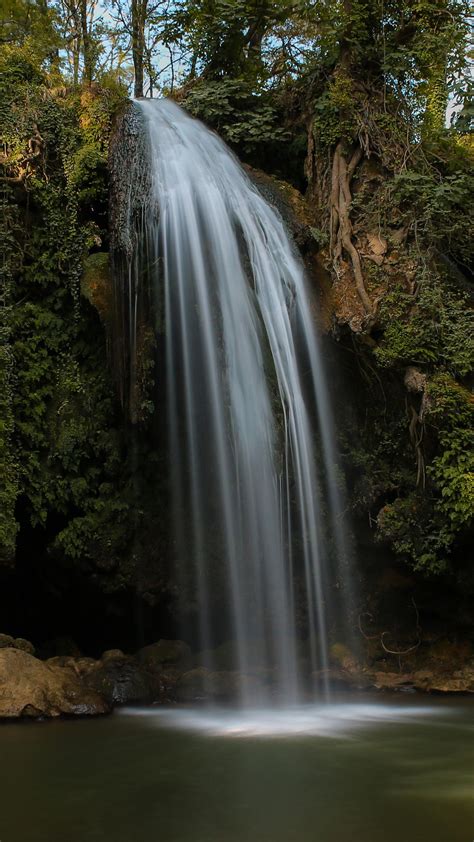 Waterfalls Pouring On Lake From Rocks Green Plants Bushes Trees 4k 5k