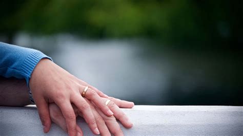 Download Husband And Wife Wedding Rings On Railing Wallpaper