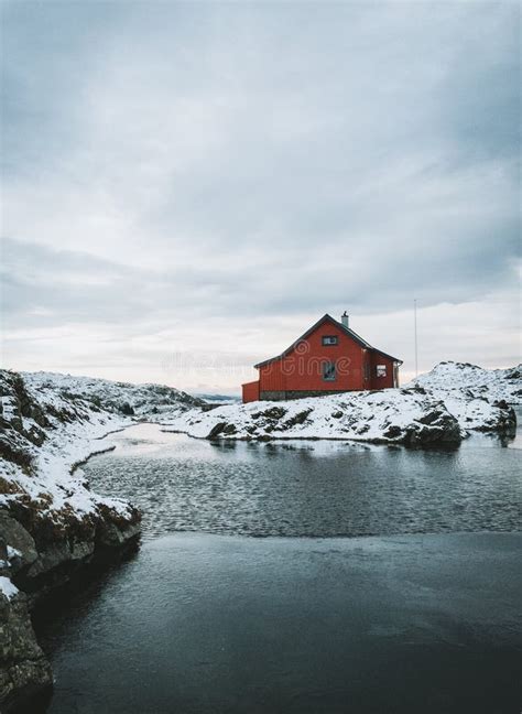 Wooden Red House At The Sea In Norway On A Mountain Peak Stock Photo