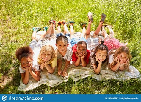 Group Of Multicultural Kids On A Meadow Stock Image - Image of camp ...
