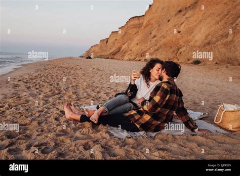 Young Couple Kissing On The Beach At Dawn Woman And Man Meeting