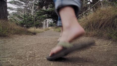 woman s feet walking on a nature trail in a cypress forest by stocksy contributor gabriel