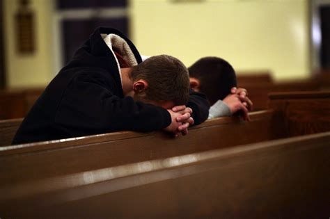 Two Men Pray At Saint Rose Of Lima Roman Catholic Church Near Sandy