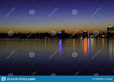City Lights Reflecting At Night Over The Water Of Herastrau Lake