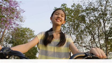 Slow Motion 4k Of Happy Asian Preteen Girl Enjoying To Ride Bicycle In The Park Stock Video