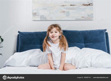 Little Girl Sitting On Bed Stock Photo By ©alebloshka 160956178