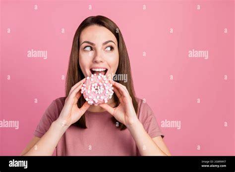 Portrait Of Attractive Funny Cheerful Hungry Girl Eating Biting Fresh Doughnut Isolated Over