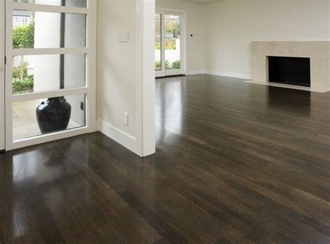 Warm toned expanses of yellowish natural white oak display an orange brown glow when flooring is stained and polished. Dark stained white oak | Dark oak flooring, Hardwood ...