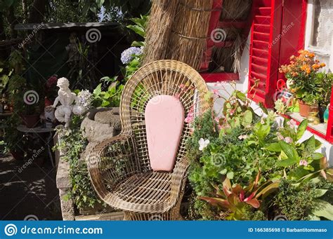 They come in handy when you are on a camping or beach trip. Pink Wicker Armchair In The Garden Under A Red Window Near ...