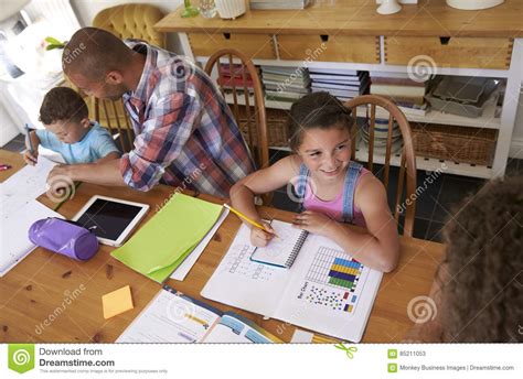 Parents Helping Children With Homework At Table Stock Image Image Of