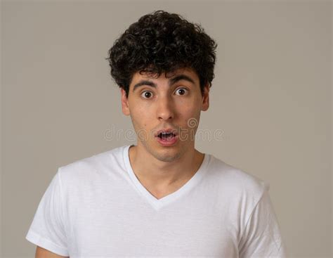 Surprised And Shocked Young Man Hearing Unexpected News Or Looking At