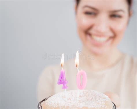 The Happy Woman Makes A Wish And Blows Out The Candles On The 40th