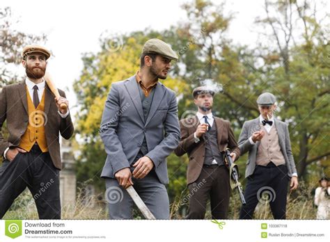 Four Gangsters Holding Several Dangerous Weapons And Looking For