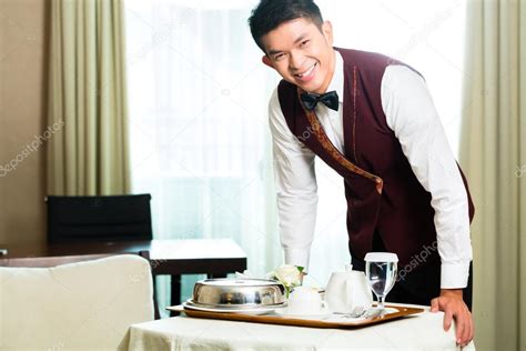 Room Service Waiter Serving Food In Hotel — Stock Photo © Kzenon 77908736
