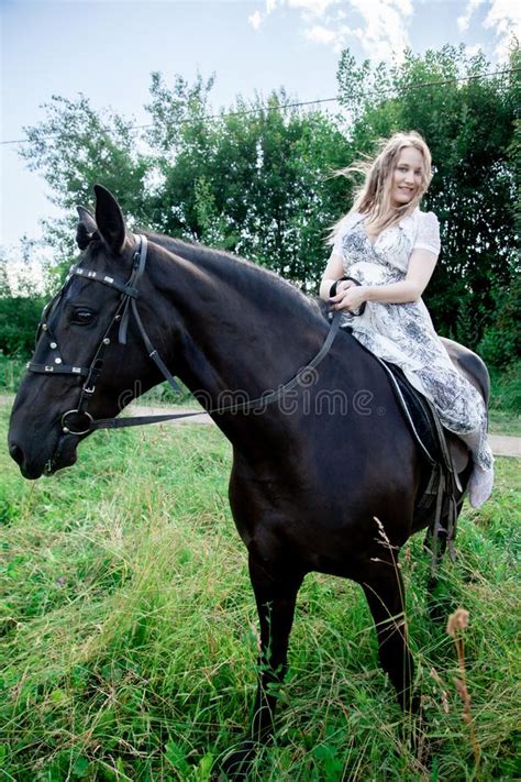 Beautiful Caucasian Young Girl Walking With A Horse And Enjoys