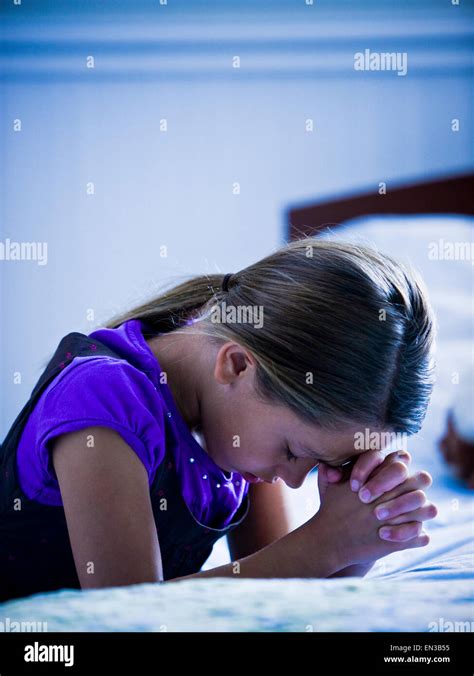 Girl Praying By Her Bed Stock Photo Alamy