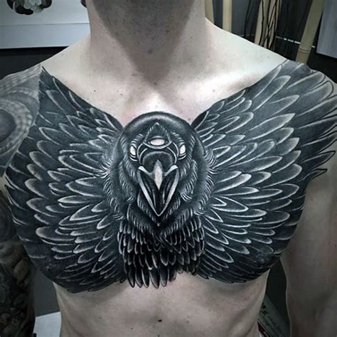 large black ink chest tattoo of big crow with tree eyes tattooimages
