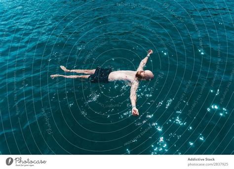 Man Floating In Blue Water A Royalty Free Stock Photo From Photocase
