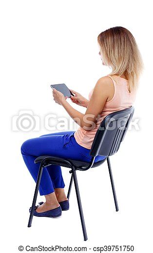 Back View Of Woman Sitting On Chair And Looks At Screen Back View Of