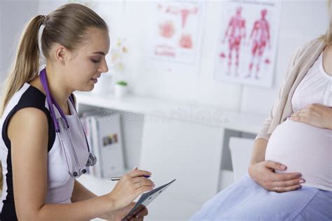 Gynecology Consultation Pregnant Woman With Her Doctor In Clinic Stock