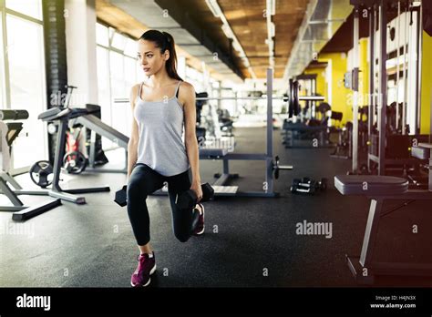 Beautiful Woman Working Out In Gym And Lifting Weights Stock Photo Alamy