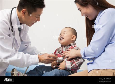 Doctor Examining Baby Boy In Office Stock Photo Alamy