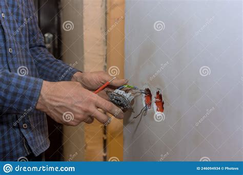 Electrician Installing A Light Switch With A Wall Stock Photo Image