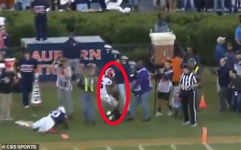 photographer is knocked unconscious by college running back who crashes into her on the sideline