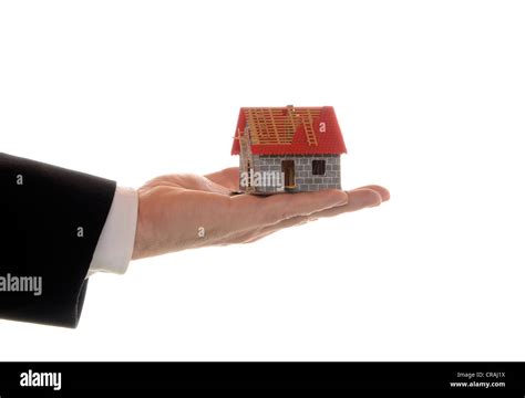 Mans Hand Holding A Model Of A House Symbolic Image For Mortgages