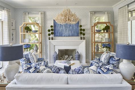 The Living Room Is Decorated In Blue And White With Two Lamps On Either