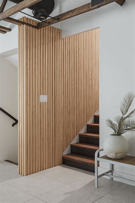 An Interior Wall With Wood Cladding Leading Up The Stairs Wood Cladding
