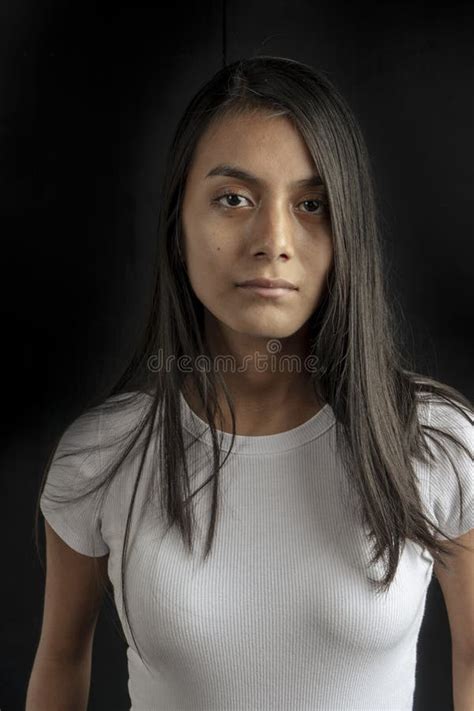 Vertical Portrait Of A Young Latina Woman Checking Her Smartphone Or