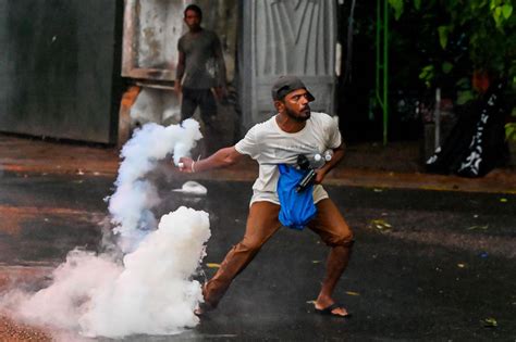 A Protester Throws Back A Tear Gas Canister Fired By Police