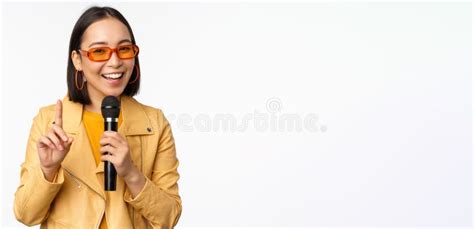 portrait of beautiful asian woman in sunglasses stylish girl singing giving speech with