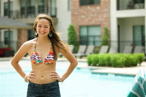 Mixed Race Girl Wearing Bikini Standing Near Swimming Pool Stock Photo Dissolve