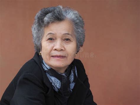 Asian Elderly Woman Looking At The Camera With A Warm Friendly Smile Stock Image Image Of