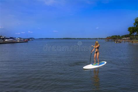 Beautiful Bikini Model Relaxing On A Paddle Board Stock Photo Image