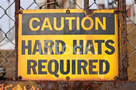 Caution Hard Hats Required Sign On A Rusty Fence Stock Photo Royalty