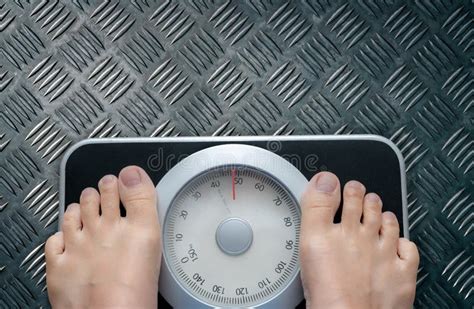 Top View Of Feet On Weighing Scale Women Weigh On A Weight Balance
