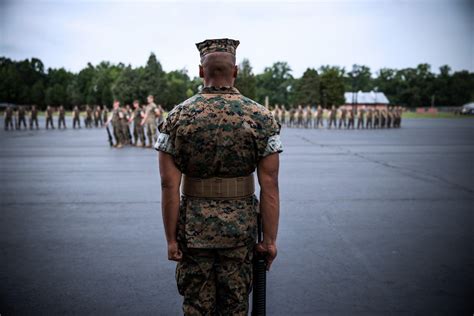 Marines Standing In Formation Of Officer Wearing Cammies