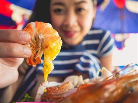 Premium Photo Close Up Of Asian Woman Eating Local Grilled Seafood Of Thailand Beach