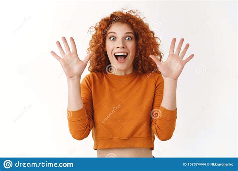 Impressed Cheerful Attractive Redhead Woman Curly Hairstyle Raising