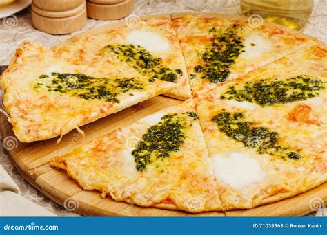 Photo Of Crunchy Pizza On Wooden Plate With Bottle Of Olive Oil Stock